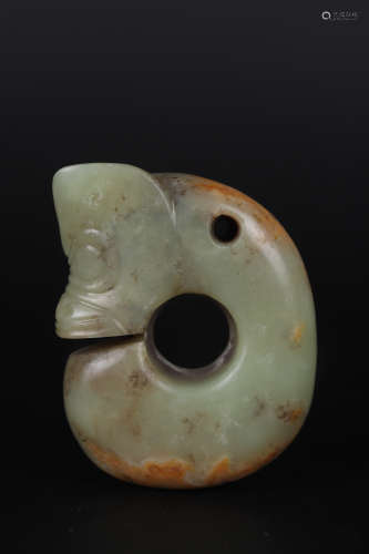 A GREENISH AND RUSSET JADE FIGURE OF A PIG