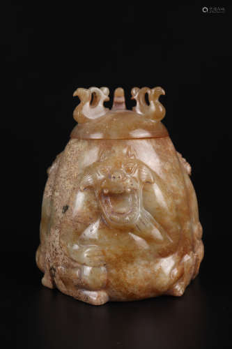 A CARVED BROWNISH JADE BEAR JAR AND COVER