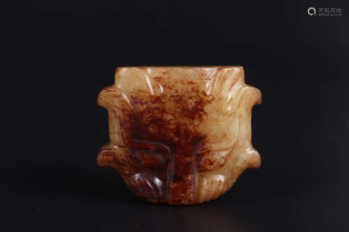 A CARVED BROWNISH JADE ORNAMENT