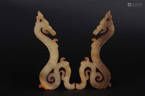 A PAIR OF CARVED BROWNISH JADE DRAGON ORNAMENTS