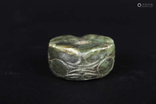 A CARVED GREEN JADE ORNAMENT