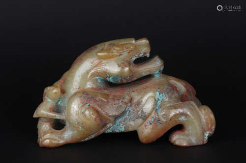 A CARVED BROWNISH JADE FIGURE OF BEAST