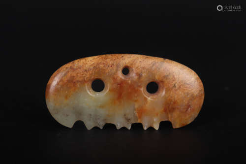 A CARVED BROWNISH JADE ORNAMENT