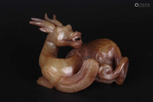 A CARVED BROWNISH JADE FIGURE OF MYTHICAL BEAST