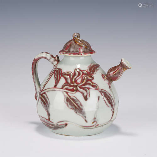 A COPPER RED FLORAL EWER