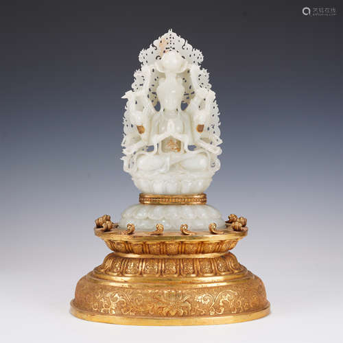 A FINE CARVED WHITE JADE SEATED GUANYIN WITH GILT-BRONZE STA...