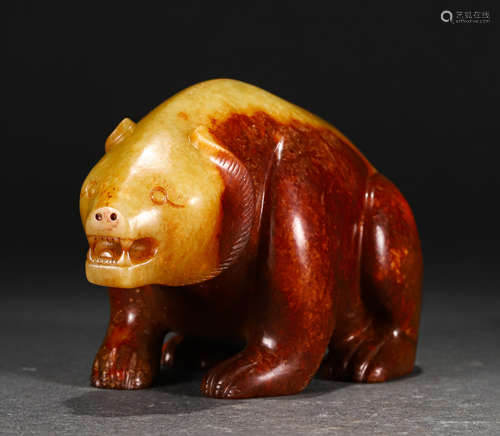 A CARVED CREAMY AND RUSSET JADE BEAR