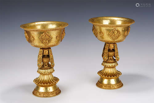 A TIBETAN HARDSTONES INLAID GILT-BRONZE RITUAL BUTTER LAMPS