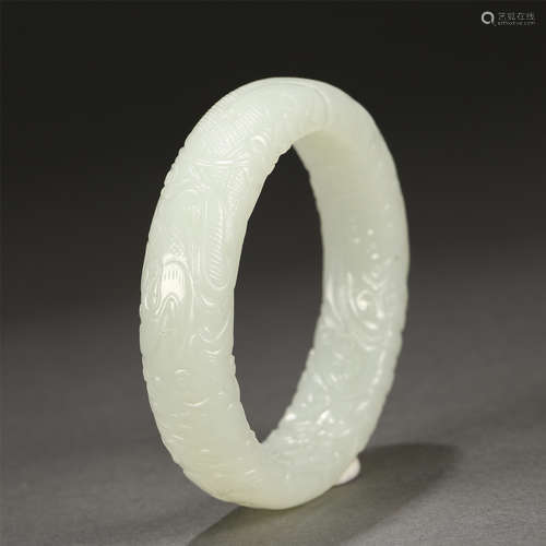 A CARVED WHTIE JADE BANGLE