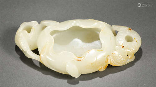 A CARVED WHITE JADE WASHER