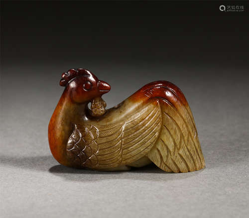 A CARVED RUSSET JADE ROOSTER