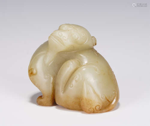 A CARVED CREAMY JADE BEAST PAPER WEIGHT QING DYNASTY