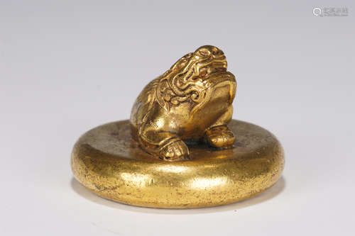 A GILT-BRONZE BEAST PAPER WEIGHT