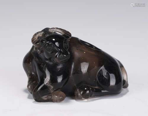 A CARVED SMOKY QUARTZ BUFFALO PAPER WEIGHT