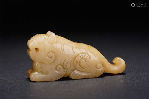 A CARVED CREAMY WHITE JADE TIGER FINIAL