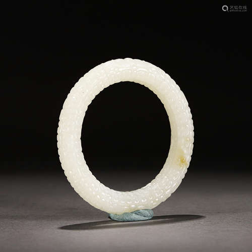 A CARVED WHITE JADE BANGLE