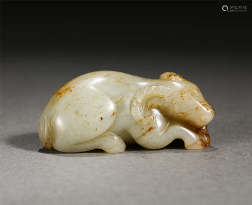 A CARVED WHITE AND RUSSET JADE RAM