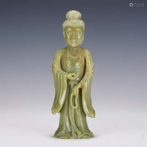 A CARVED CELADON JADE STANDING GUANYIN