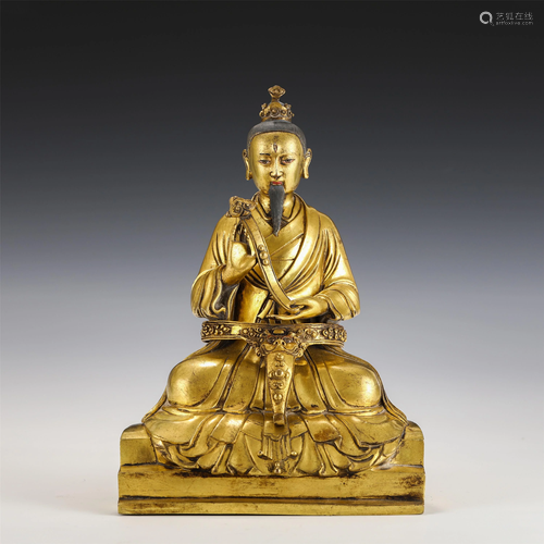 A GILT-BRONZE SEATED TAOISM FIGURE