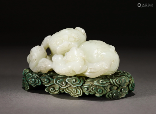 A CARVED WHITE JADE BEASTS GROUP