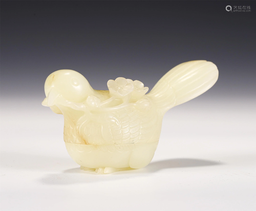 A CARVED CREAMY JADE MAGPIE