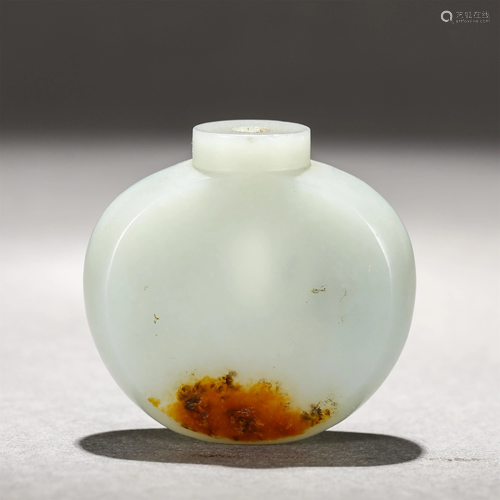 A CARVED WHITE JADE SNUFF BOTTLE