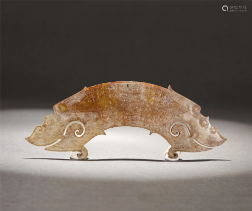 A CARVED RUSSET JADE HUANG