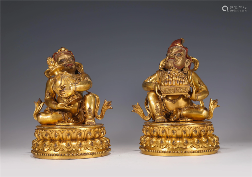 A PAIR OF GILT-BRONZE SEATED GUARDIANS