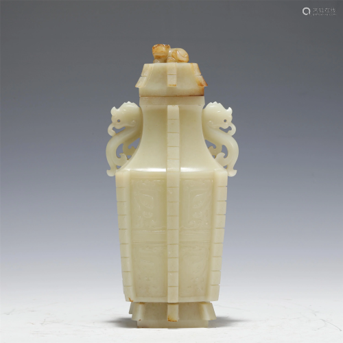 A CARVED WHITE JADE VASE WITH DOUBLE HANDLES