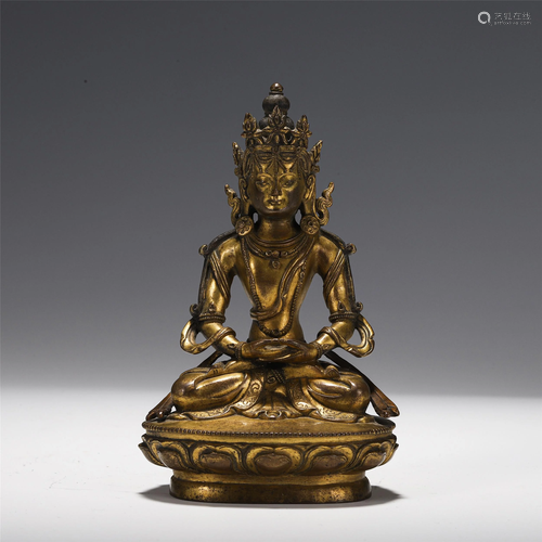 A GILT-BRONZE SEATED CROWNED BUDDHA