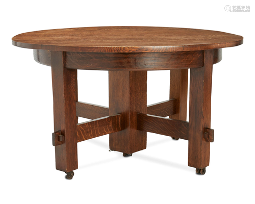 An Arts and Crafts-style extendable oak dining table