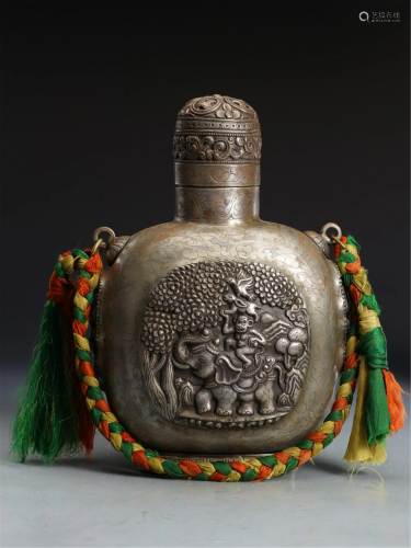 A TIBETAN STYLE SILVER CARVED BOTTLE AND COVER