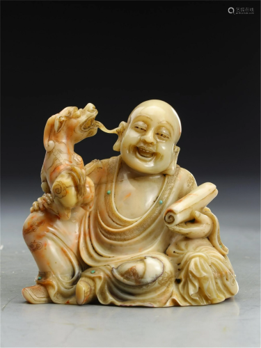 A CHINESE SOAPSTONE CARVING OF ARHAT AND LION