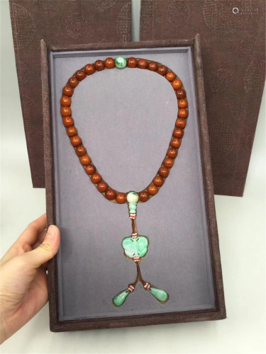 A STRING OF CLOUDY-AMBER AND JADEITE PRAYER BEADS