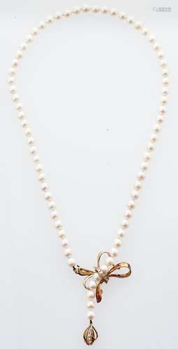 A cultured pearl necklace with diamond set 14ct gold bow cla...