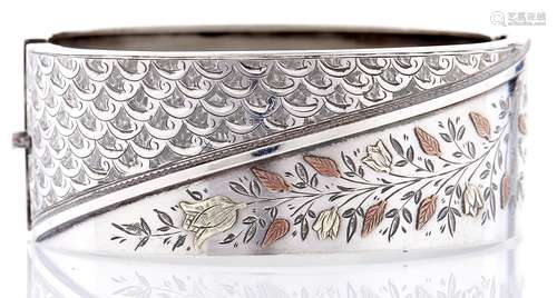 An aesthetic silver bangle, c1880, with coloured gold applie...