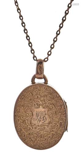 An Edwardian oval 9ct gold locket, foliate engraved, Birming...