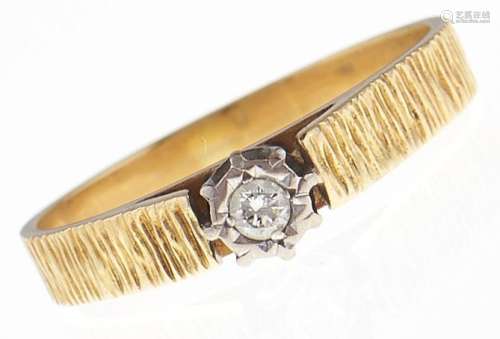 A diamond solitaire ring, in bark textured gold marked 18ct,...