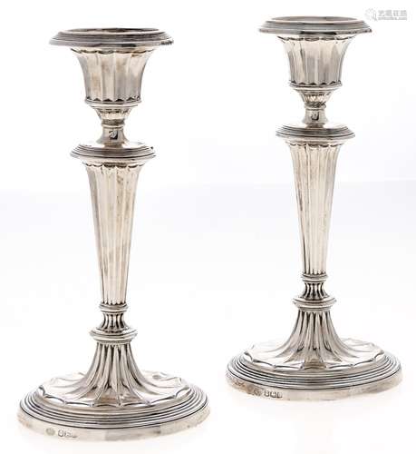 A pair of George V silver candlesticks, in neo classical sty...