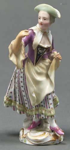 A Thuringian porcelain figure of a woman, 19th c, in puce bo...