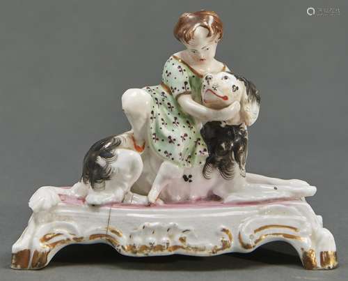 A Staffordshire bone china figure of a child with a spaniel,...