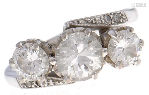 A three stone diamond crossover ring, with round brilliant c...