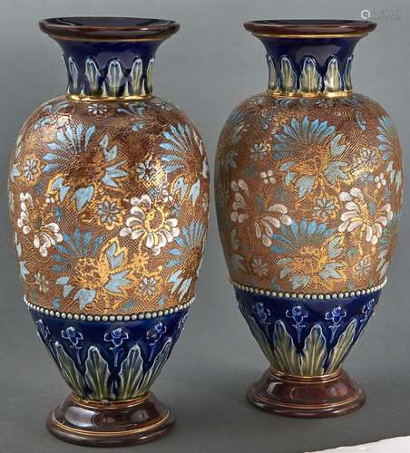 A pair of Doulton ware blue ground vases with chine gilt dec...