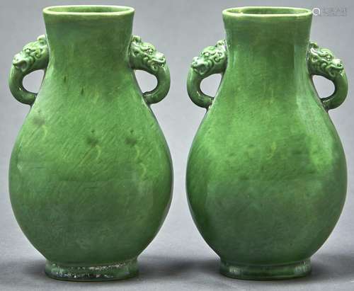 A pair of Chinese archaic style green monochrome glazed vase...