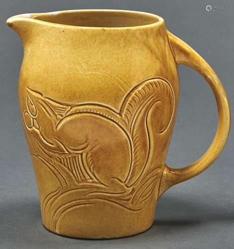 Susie Cooper. A yellow glazed earthenware squirrels jug, dat...