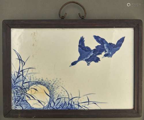 A Chinese blue and white plaque, painted with geese and bamb...