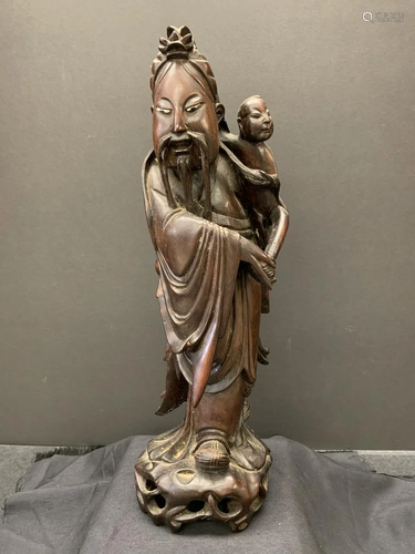 Wood carving of an old man and a boy