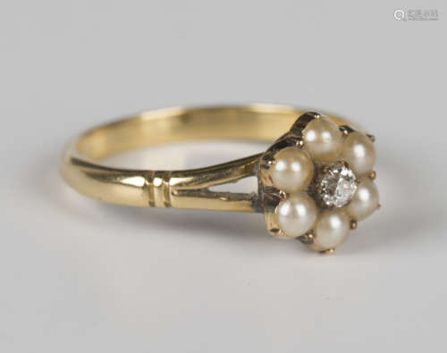 A gold, diamond and half-pearl cluster ring, mounted with a ...