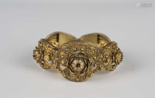 A silver gilt filigree bracelet in a curved oval panel shape...