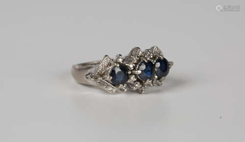 A white gold, sapphire and diamond ring, claw set with three...